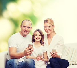 Image showing happy family with smartphones