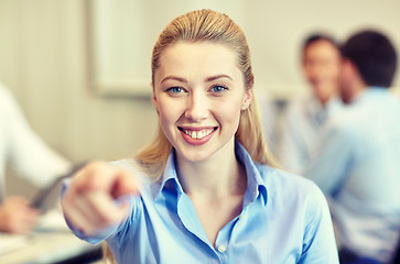 Image showing smiling businesswoman pointing finger on you