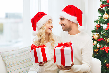 Image showing happy couple at home exchanging christmas gifts