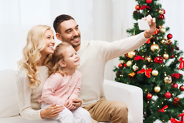 Image showing family taking selfie with smartphone at christmas