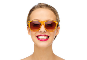 Image showing happy young woman in sunglasses with pink lipstick