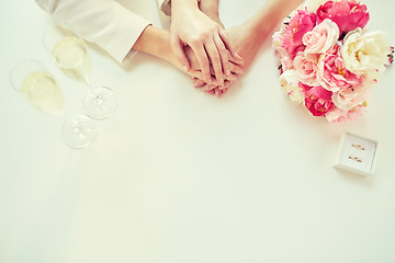 Image showing close up of lesbian couple hands and wedding rings