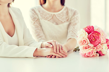 Image showing close up of happy lesbian couple with flowers