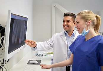Image showing dentists with x-ray on monitor at dental clinic