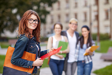Image showing happy teenage students with school folders