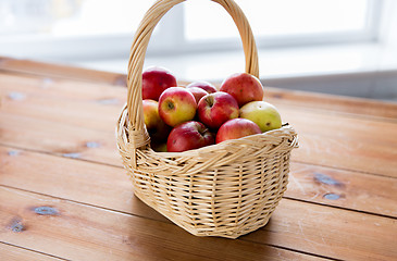 Image showing close up of basket with apples on wooden table