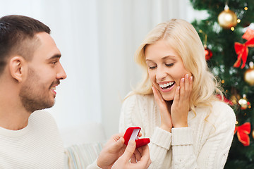 Image showing man giving woman engagement ring for christmas