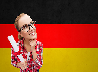 Image showing smiling student with diploma over german flag