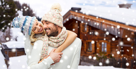 Image showing smiling couple in winter clothes hugging outdoors