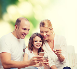 Image showing happy family with smartphones