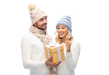 Image showing smiling couple in winter clothes with gift box