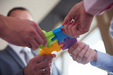 Image showing business people group assembling jigsaw puzzle