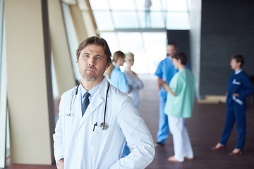 Image showing group of medical staff at hospital, handsome doctor in front of 