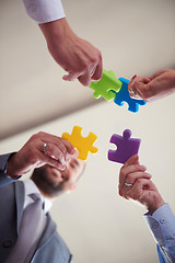 Image showing business people group assembling jigsaw puzzle