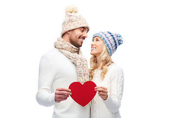 Image showing smiling couple in winter clothes with red heart