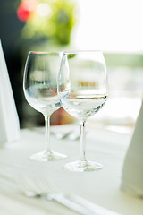 Image showing close up of two wine glasses on restaurant table