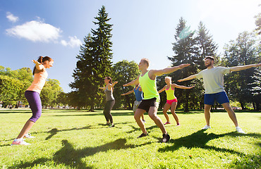 Image showing group of happy friends exercising outdoors