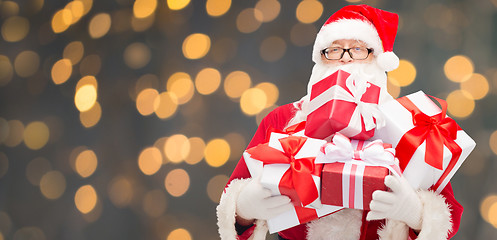 Image showing man in costume of santa claus with gift boxes