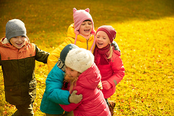 Image showing group of happy children hugging in autumn park