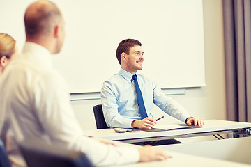 Image showing group of smiling businesspeople meeting in office