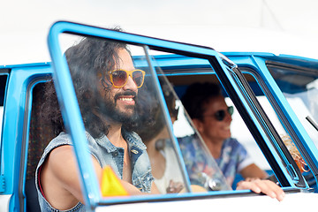 Image showing smiling young hippie friends in minivan car