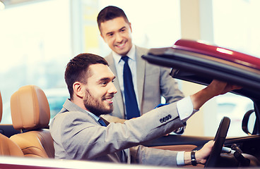 Image showing happy man with car dealer in auto show or salon