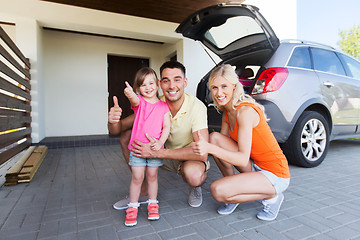 Image showing happy family with car showing thumbs up at parking