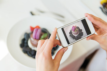 Image showing close up of woman picturing food by smartphone