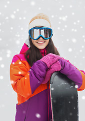 Image showing happy young woman with snowboard outdoors