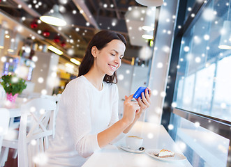 Image showing smiling woman with smartphone and coffee at cafe