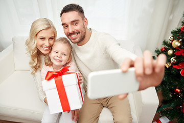 Image showing family taking selfie with smartphone at christmas