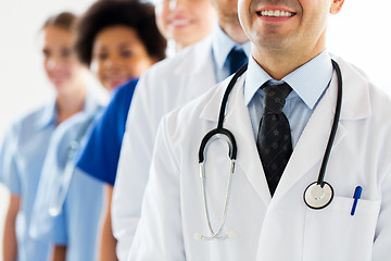 Image showing close up of happy doctors with stethoscope