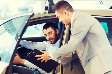 Image showing happy man with car dealer in auto show or salon