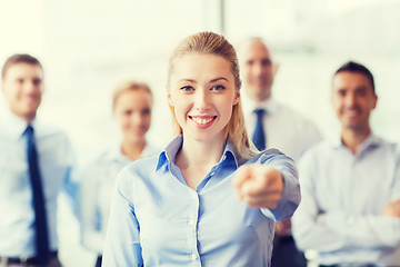 Image showing smiling businesswoman pointing finger on you