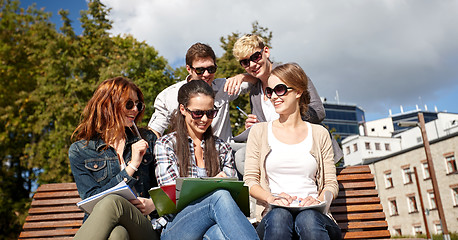 Image showing group of happy students with notebooks at campus