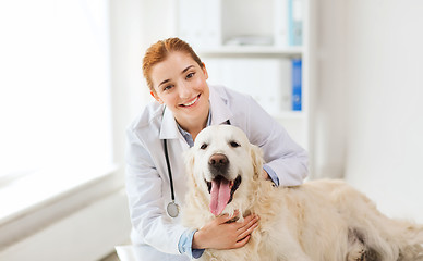 Image showing happy doctor with retriever dog at vet clinic
