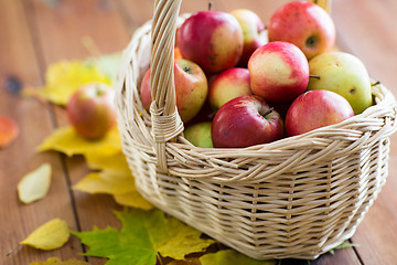 Image showing close up of basket with apples on wooden table