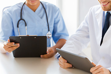 Image showing doctors with tablet pc and clipboard at hospital