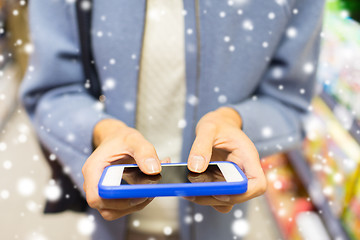 Image showing close up of woman with smartphone in market