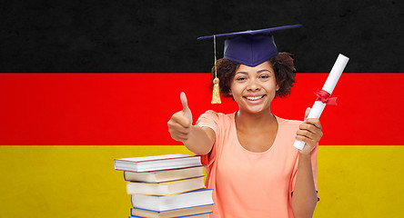 Image showing happy bachelor girl with diploma showing thumbs up