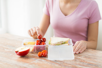 Image showing close up of woman with food in plastic container