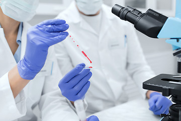 Image showing close up of scientists filling perti dish in lab