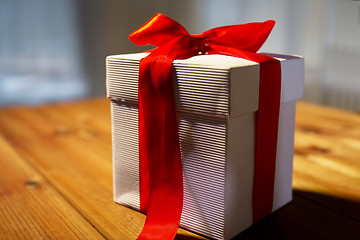 Image showing close up of christmas gift box on wooden table