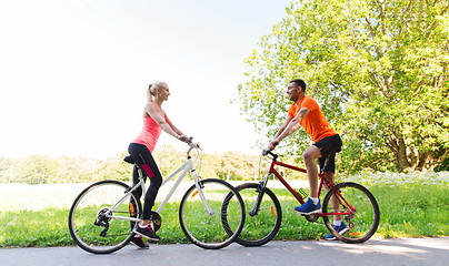 Image showing happy couple riding bicycle outdoors