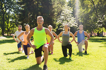 Image showing group of friends or sportsmen exercising outdoors