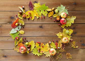 Image showing set of autumn leaves, fruits and berries on wood