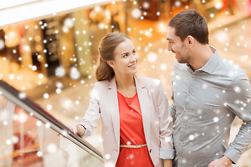 Image showing couple with shopping bags on escalator in mall