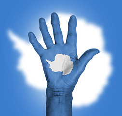 Image showing Palm of a woman hand, painted with flag