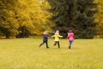 Image showing group of happy little kids running outdoors