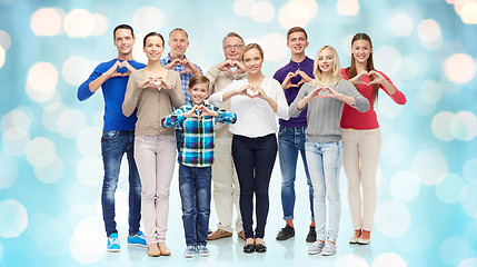 Image showing group of smiling people showing heart hand sign